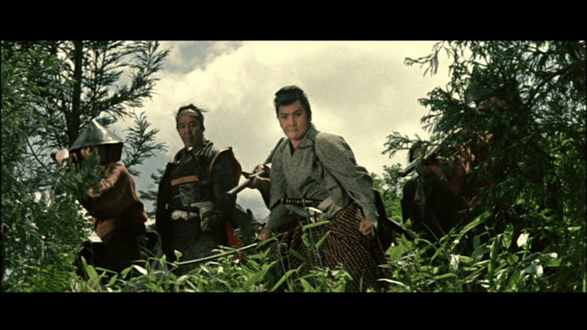 A group of samurai warriors in traditional attire navigating through dense greenery, with one prominent figure looking intently at the viewer, surrounded by others in the background.